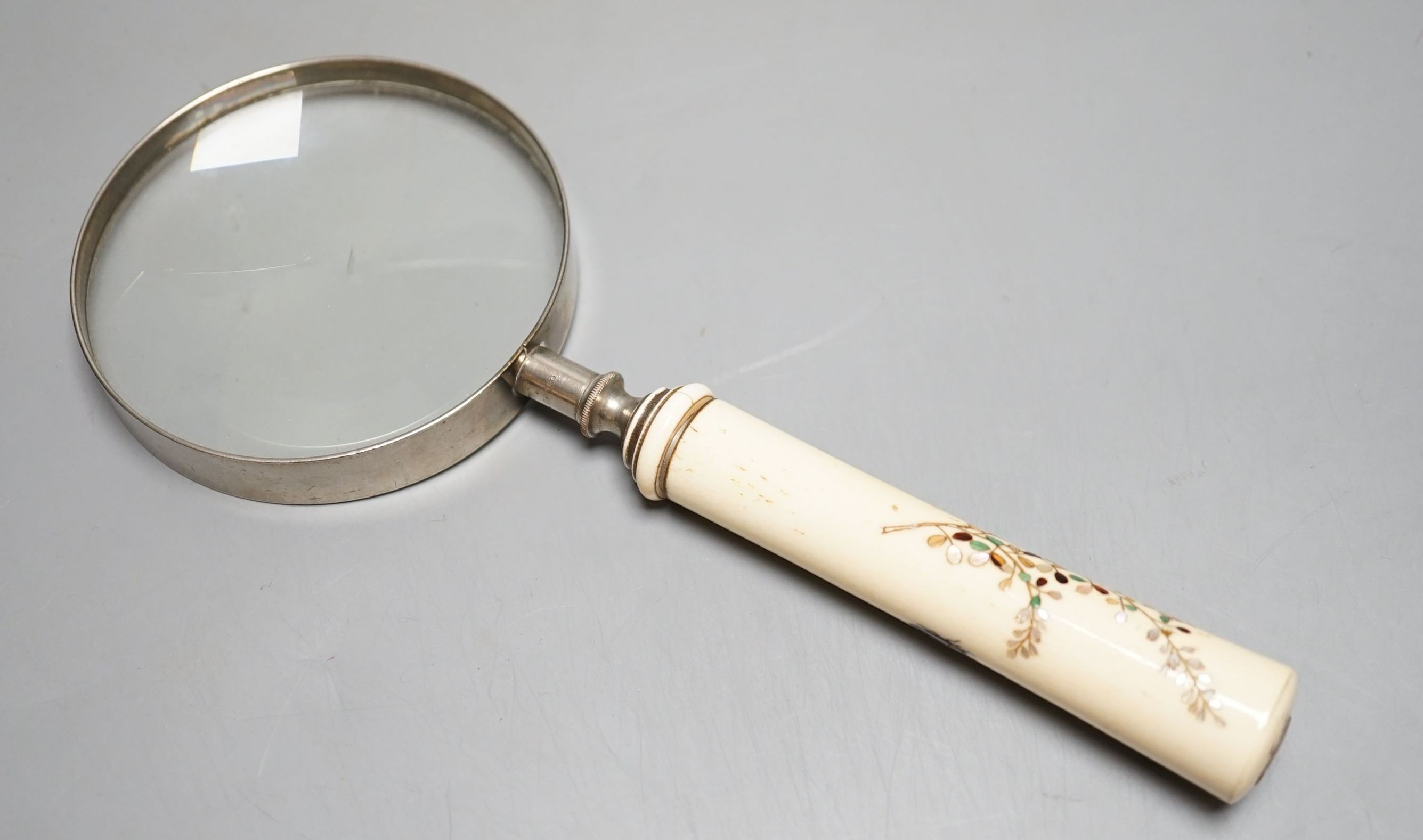 A Japanese Shibayama ivory and bone inlay handled magnifying glass decorated with insects and blossom, handle 11 cms long.